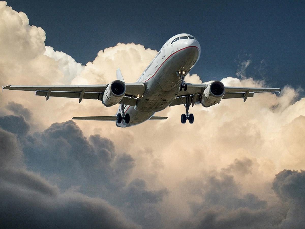 White and Red Plane Beside Clouds
